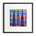 Framed abstract geometric wall art inspired by desert life and mountains featuring overlapping translucent triangles and diagonal lines in red, blue, green, purple, and black on a white mat, presented in a black frame against a light gray background.