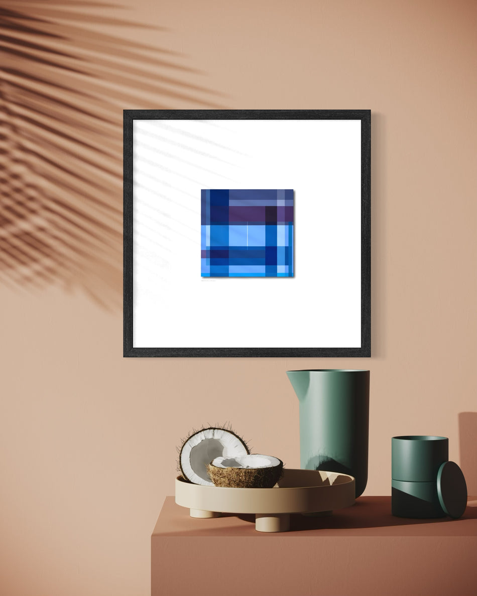 A contemporary spiritual framed abstract art print featuring a blue and purple pixelated plaid square on a white background, styled in a minimalist interior setting with a terracotta wall, palm leaf shadow, and modern green ceramic objects on a matching terracotta pedestal.